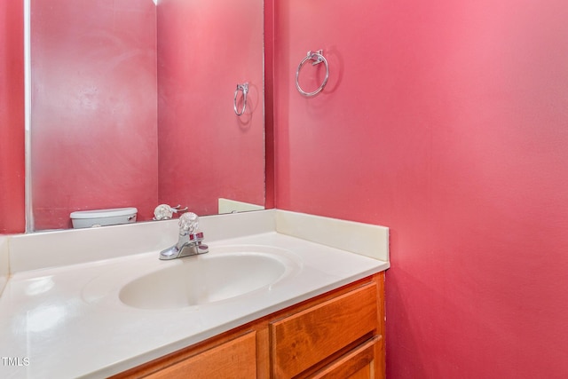 bathroom featuring toilet and vanity