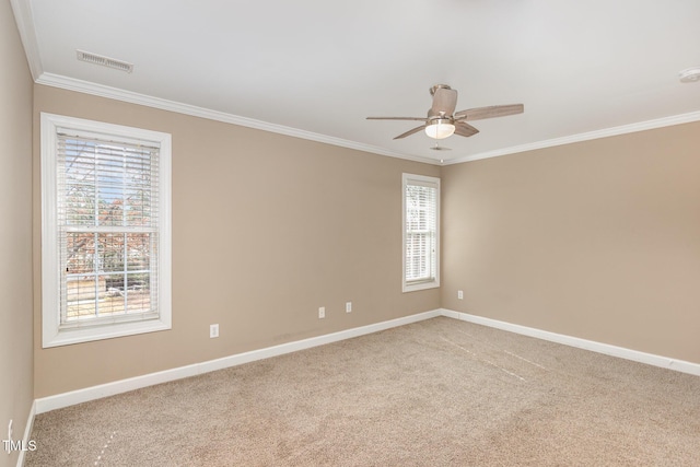 empty room with visible vents, ornamental molding, and light colored carpet