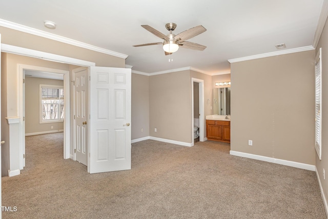 unfurnished bedroom featuring light carpet, ornamental molding, ensuite bath, and baseboards