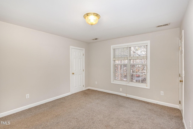 carpeted empty room with baseboards and visible vents