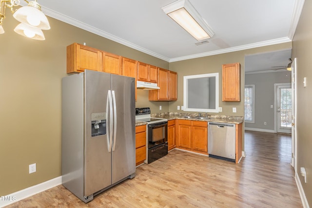 kitchen with under cabinet range hood, ornamental molding, stainless steel appliances, and light wood-style floors