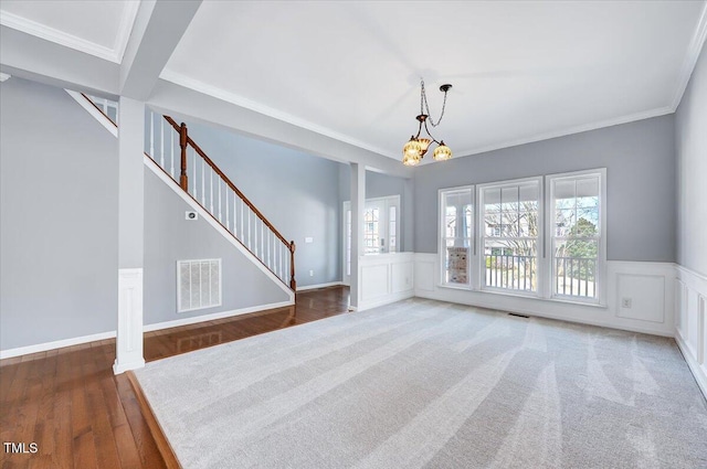 interior space with stairway, plenty of natural light, visible vents, and a decorative wall