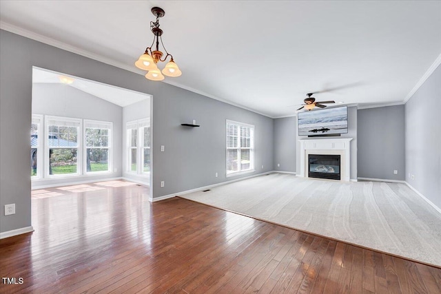 unfurnished living room with hardwood / wood-style floors, ornamental molding, and a large fireplace