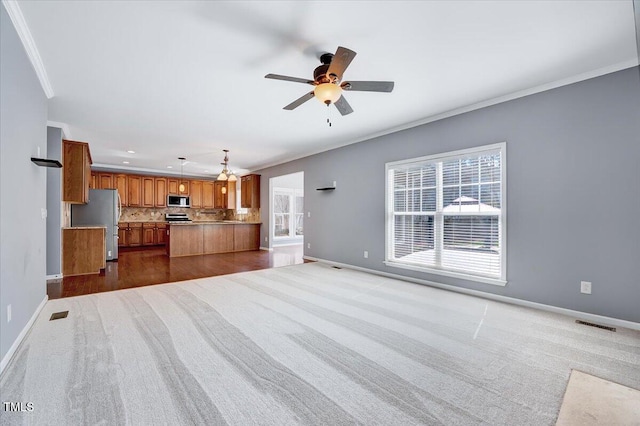 unfurnished living room featuring baseboards, recessed lighting, ceiling fan, ornamental molding, and dark colored carpet