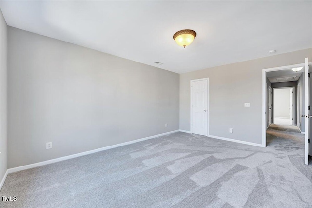 unfurnished bedroom with carpet flooring, visible vents, and baseboards