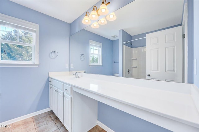 bathroom with tile patterned flooring, baseboards, walk in shower, toilet, and vanity