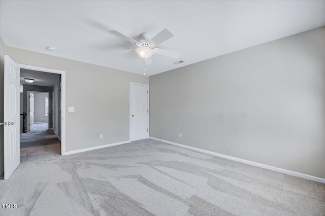 unfurnished bedroom with a ceiling fan, baseboards, and light carpet