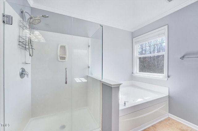 full bathroom featuring a shower stall, a bath, crown molding, and baseboards