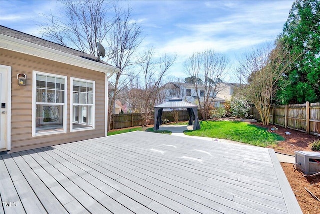 wooden terrace with a gazebo, a yard, and a fenced backyard