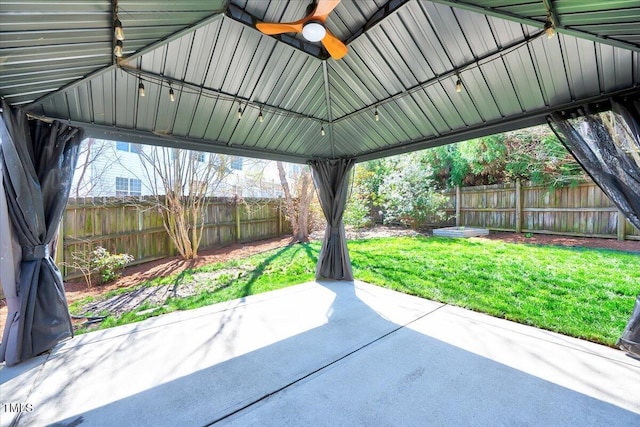 view of patio / terrace with a ceiling fan, a gazebo, and a fenced backyard