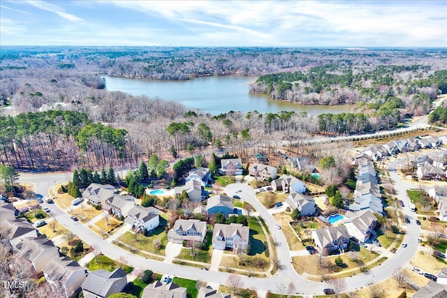 bird's eye view featuring a residential view, a water view, and a wooded view