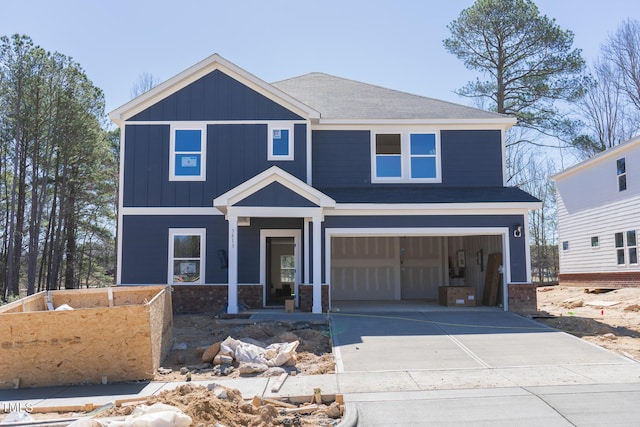 view of front facade with board and batten siding, concrete driveway, and a garage