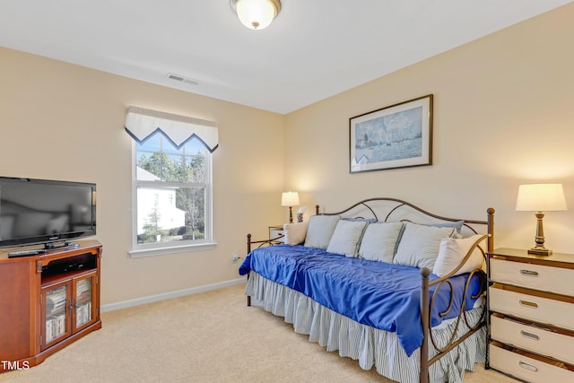 bedroom with light carpet, visible vents, and baseboards