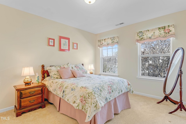 bedroom featuring light carpet, baseboards, and visible vents