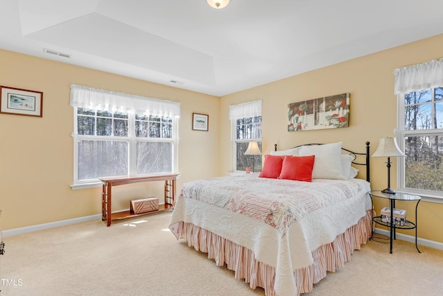 bedroom featuring light colored carpet, visible vents, and baseboards