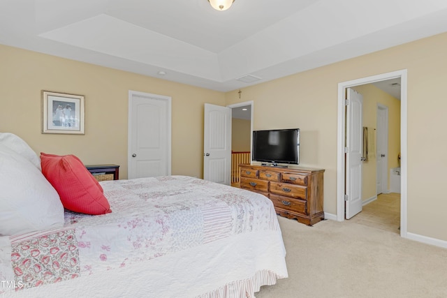 bedroom featuring baseboards, a raised ceiling, and light colored carpet