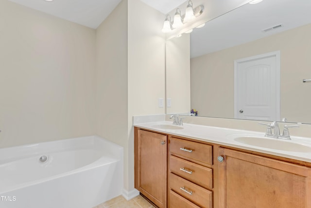 full bath with visible vents, a sink, a bath, and double vanity