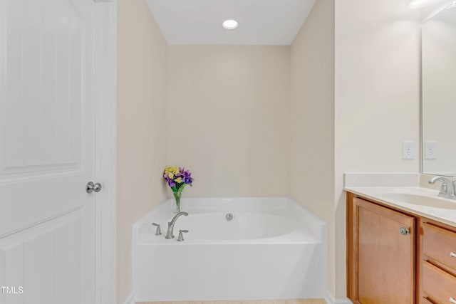 bathroom featuring vanity and a bath