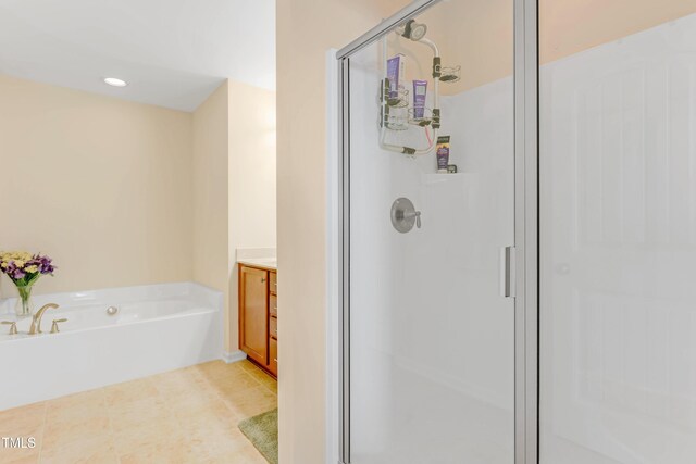 bathroom featuring recessed lighting, a stall shower, vanity, a bath, and tile patterned floors