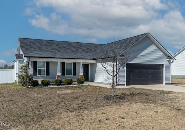 view of front facade featuring a garage, driveway, roof with shingles, and a front yard