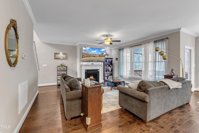 living area featuring ornamental molding, dark wood-style flooring, and visible vents