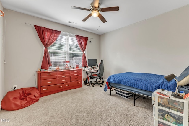 bedroom with ceiling fan, visible vents, and light colored carpet