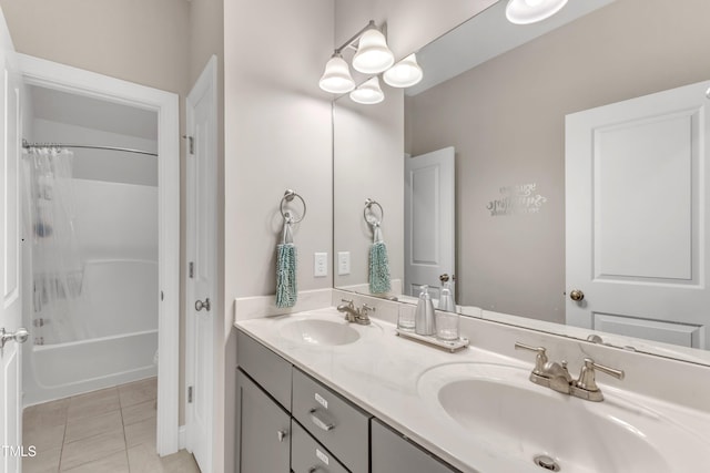 bathroom featuring double vanity, shower / bath combo, a sink, and tile patterned floors