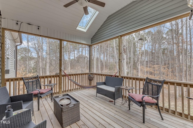 wooden terrace featuring outdoor lounge area and a ceiling fan