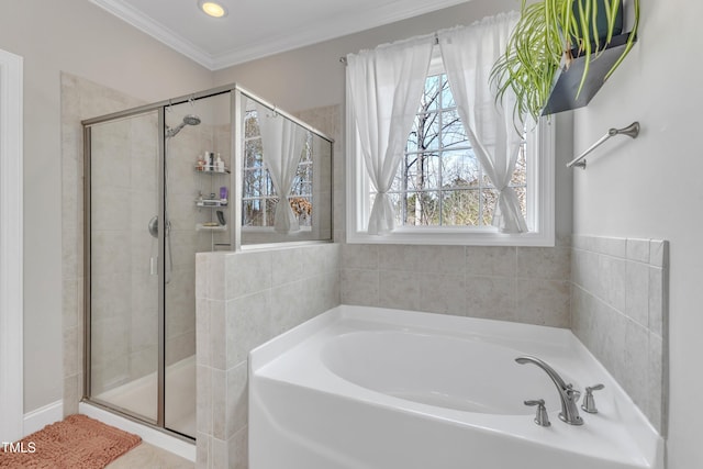 bathroom with a stall shower, ornamental molding, and a garden tub