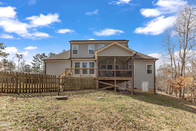 rear view of house featuring a shingled roof, fence, a lawn, and a wooden deck