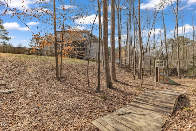 view of yard with a playground and fence