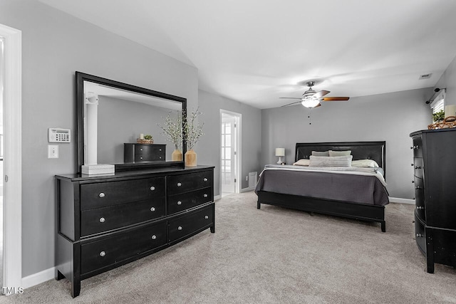 bedroom with a ceiling fan, light carpet, visible vents, and baseboards