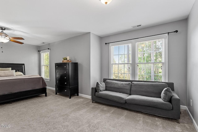 carpeted bedroom with visible vents and baseboards