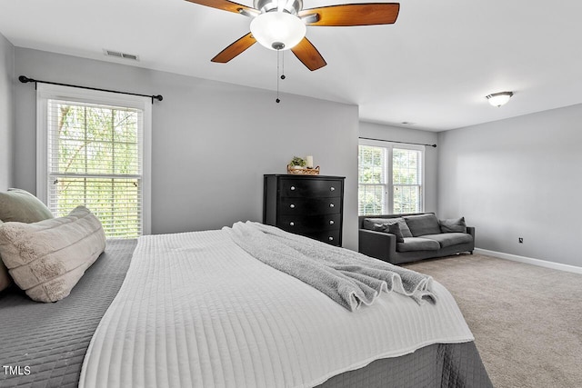 carpeted bedroom with visible vents, ceiling fan, and baseboards