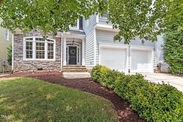 doorway to property with driveway, a garage, stone siding, roof with shingles, and crawl space