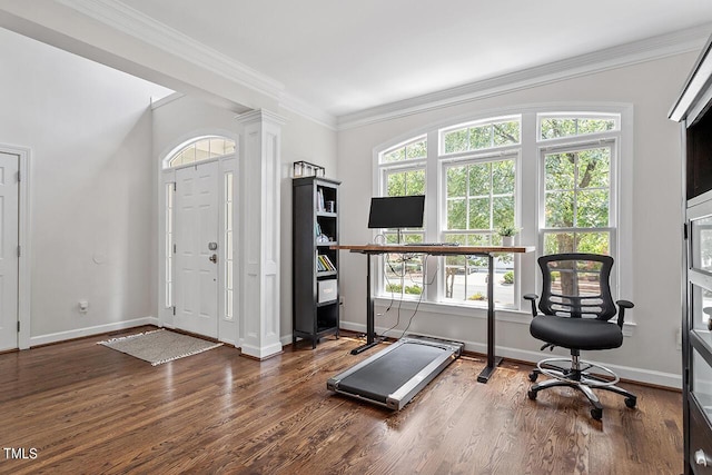 entrance foyer with baseboards, wood finished floors, decorative columns, and crown molding