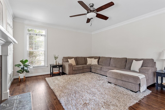 living room featuring baseboards, dark wood-style floors, a fireplace with flush hearth, ceiling fan, and crown molding