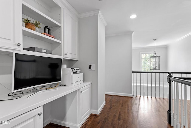 office with an inviting chandelier, ornamental molding, dark wood-style flooring, and built in study area