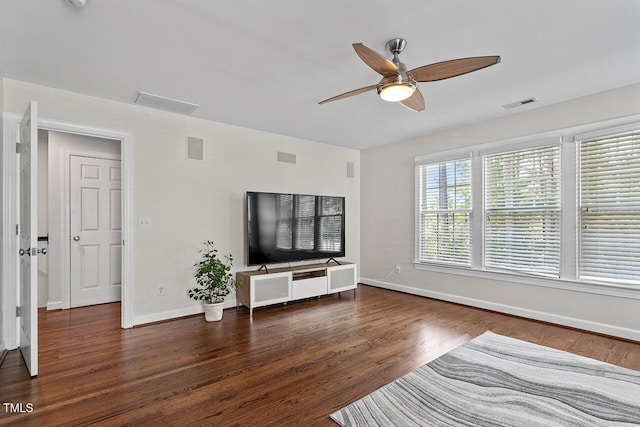 unfurnished living room with baseboards, visible vents, ceiling fan, and wood finished floors