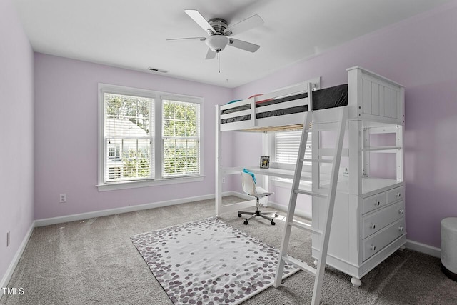 carpeted bedroom featuring baseboards, visible vents, and a ceiling fan