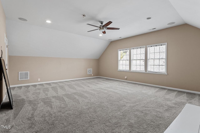 additional living space featuring lofted ceiling, carpet flooring, visible vents, and baseboards