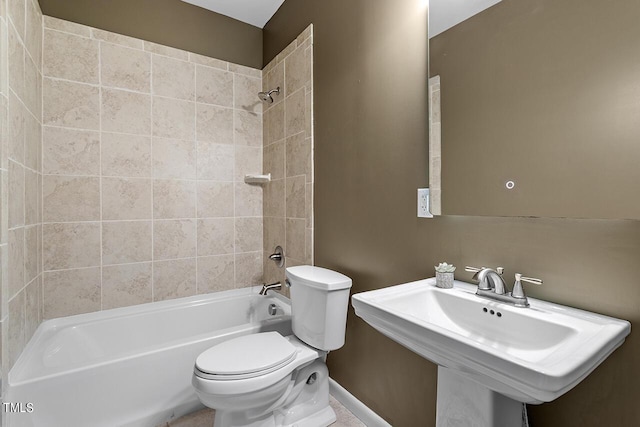 full bathroom with washtub / shower combination, a sink, and toilet