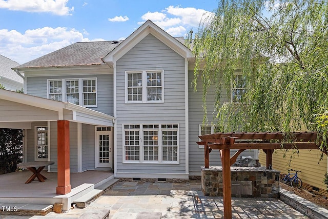 back of house featuring crawl space, roof with shingles, a patio area, and a pergola