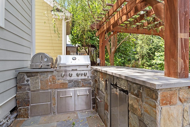 view of patio / terrace with an outdoor kitchen, a pergola, and area for grilling