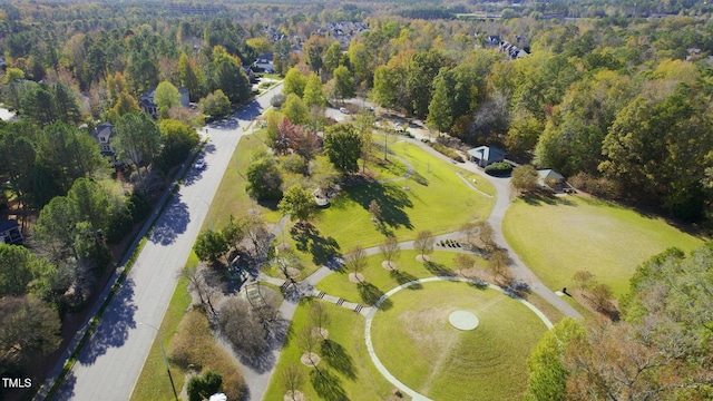 birds eye view of property featuring a forest view