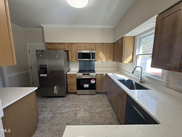 kitchen with ornamental molding, appliances with stainless steel finishes, a sink, and brown cabinets