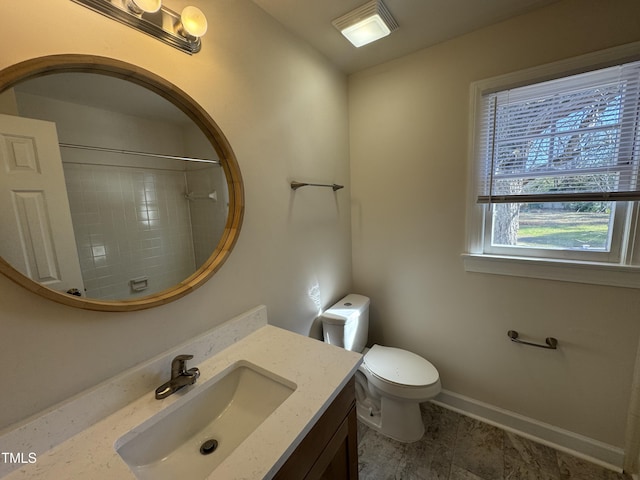 full bathroom with toilet, baseboards, walk in shower, and vanity