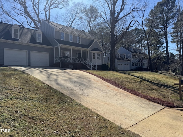 view of front of house featuring a garage, covered porch, concrete driveway, and a front yard