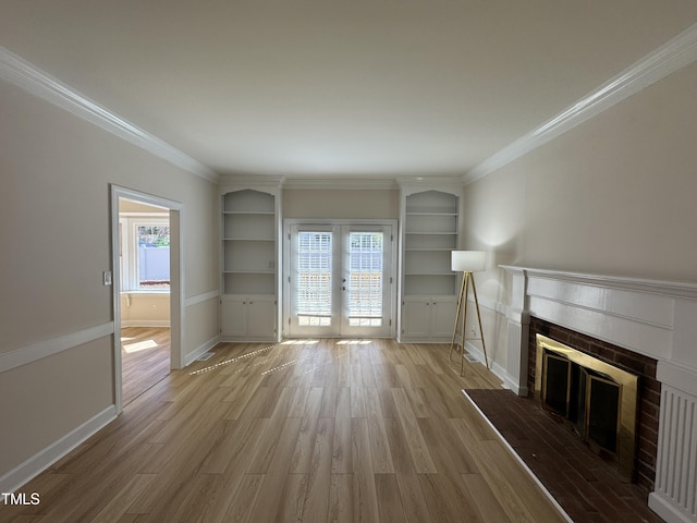 unfurnished living room with ornamental molding, a tile fireplace, and wood finished floors