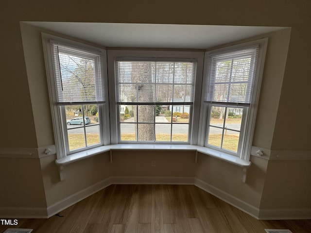 interior space featuring wood finished floors and baseboards